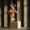 sportswoman-jumps-on-crossfit-box-in-gym-DKVMMKC-min.jpg